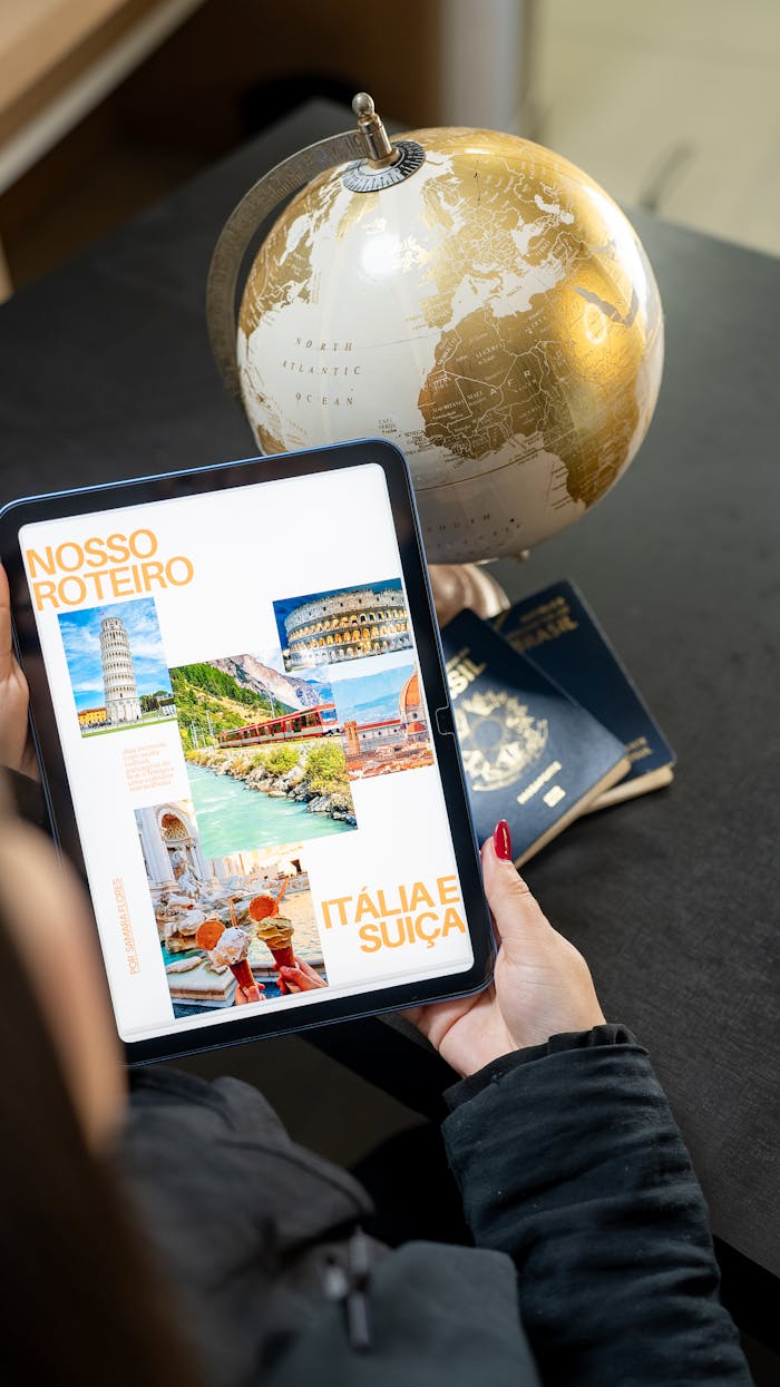 services-01 Traveler planning a trip to Italy and Switzerland using a globe, tablet, and passports.